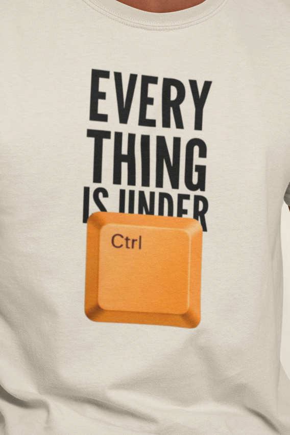 Man wearing a t-shirt with a graphic and text, sitting on a stool against a plain background